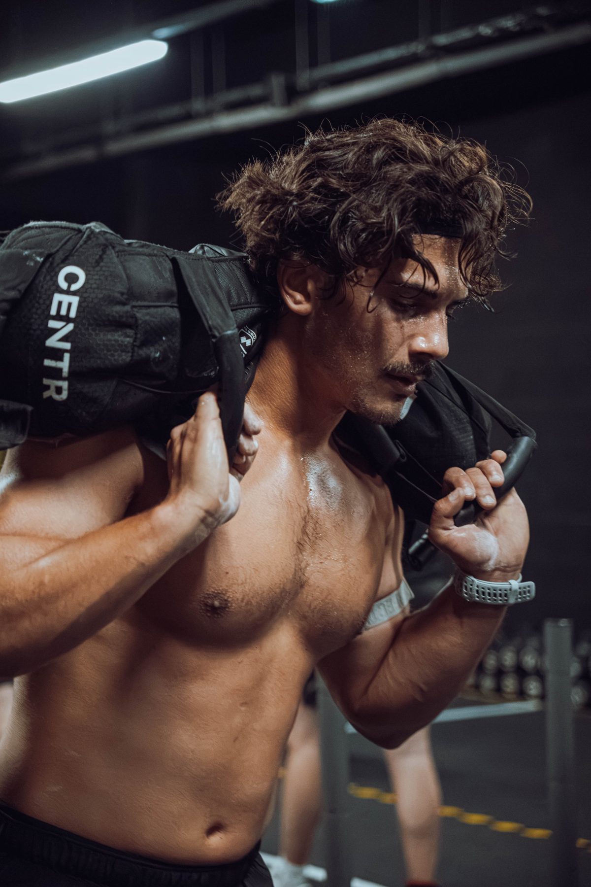 Athlete carrying a sandbag